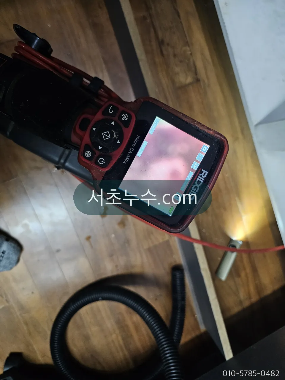 세대 안에서 내시경 장비로 배관 상태를 확인하는 모습